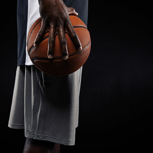 African basketball player holding ball