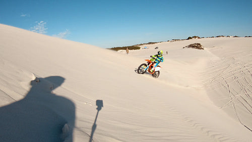 Motocross athlete creating dust while riding in a desert