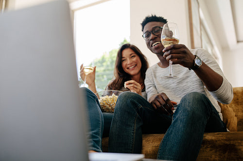 Couple enjoying free time at home watching movie
