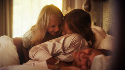 Mother and children enjoy playful morning moments together at a luxury resort