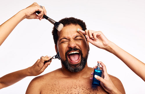 Bearded man groomed by many hands