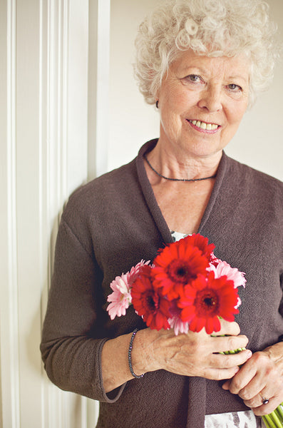 Senior Woman Holding a Bouquet of Fresh Flowers