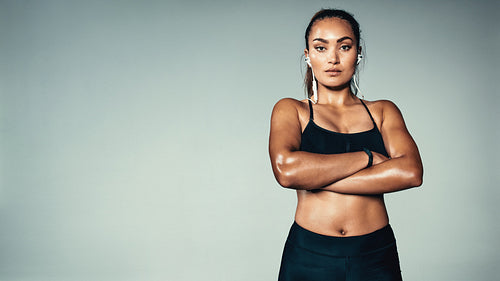 Fitness woman standing confidently