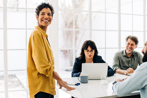 Black business woman having a meeting with her team in a boardroom
