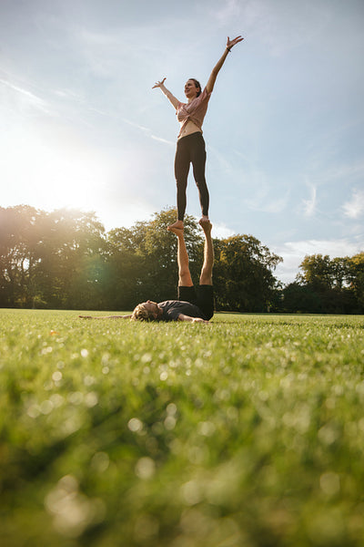Couple doing acroyoga exercise in park