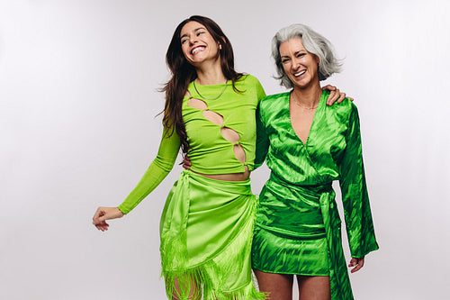 Mother and daughter laughing with arms around each other