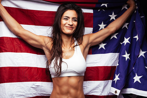 Young sportswoman holding American flag