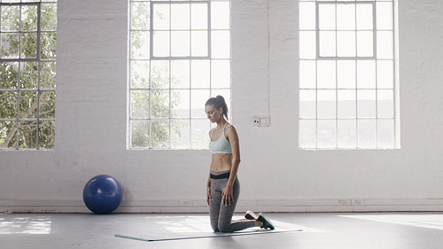 Woman doing child pose in yoga studio