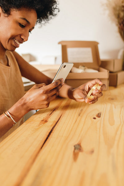 Jewelry designer taking photo of jewelry article