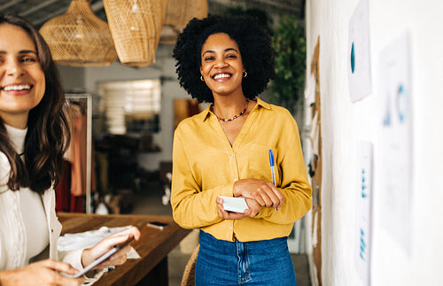 Happy business woman brainstorming with her colleague in an office