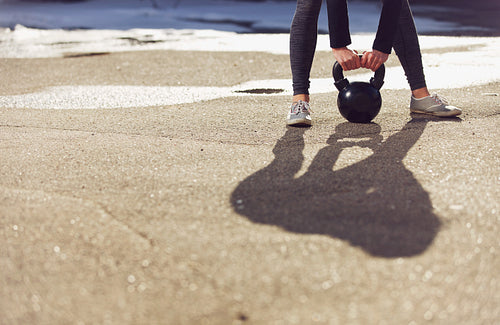 Shadow of a trainer lifting kettlebell