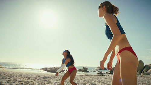 Handheld shot of two young professional athletes winning a point in a game of beach volleyball