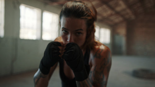Female athlete training boxing moves in gym