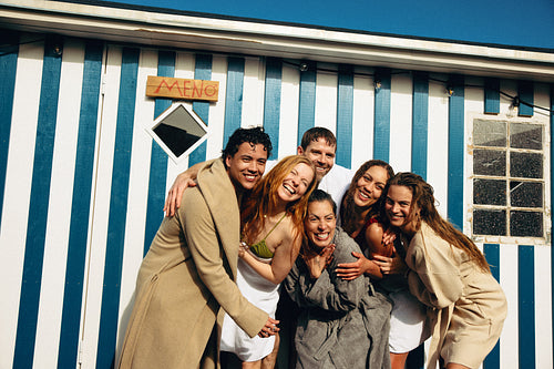 Wellness friends outside sauna bathhouse sharing Nordic hot and cold therapy community ritual