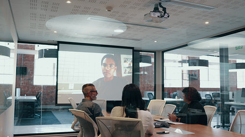 Online business meeting in a boardroom with a group of diverse professionals
