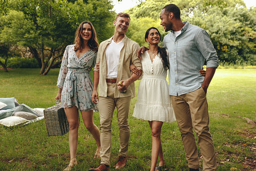 Cheerful friends on picnic in the park