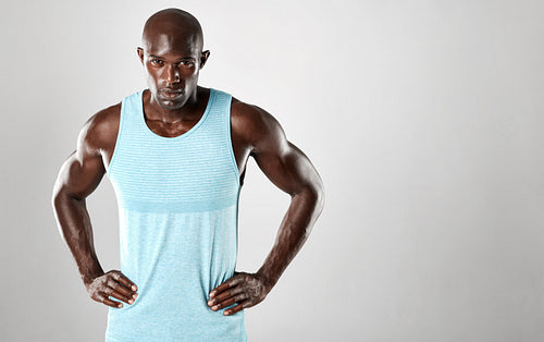 Healthy young african man standing against grey background