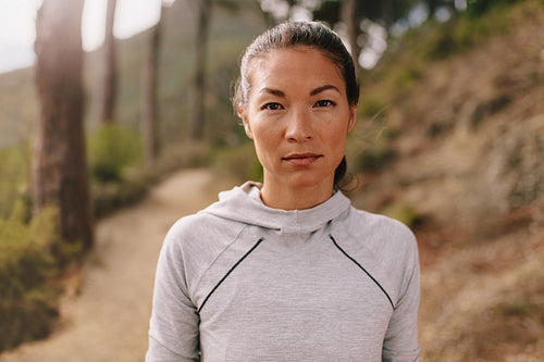 Asian woman runner on country road