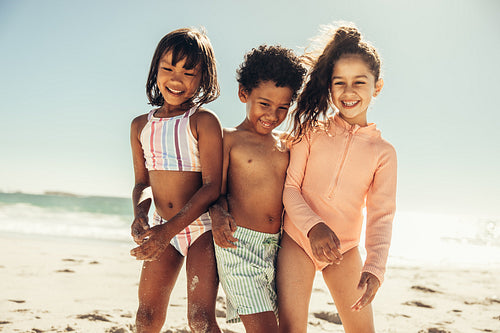 Carefree little kids having a good time at the beach