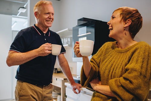 Smiling colleagues taking coffee break in office