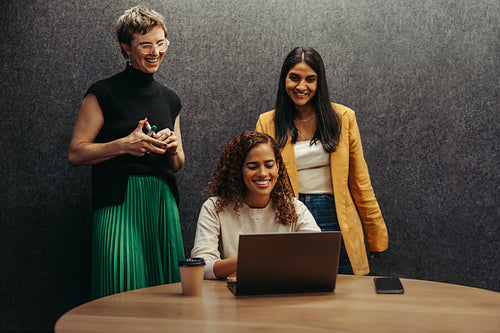 Team of businesswomen collaborating in a planning session with a laptop
