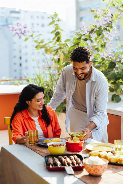 Friends enjoying a rooftop meal together on a sunny day outdoors