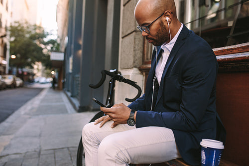 Businessman relaxing outdoors using phone