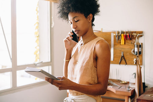 Jewelry workshop owner taking orders online