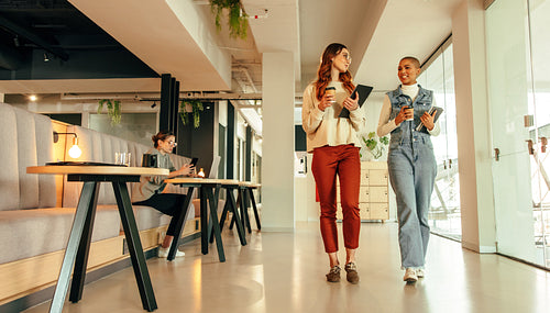 Young businesswomen walking through a modern office