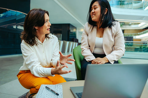 Business manager mentoring new recruit for finance assurance and consulting services