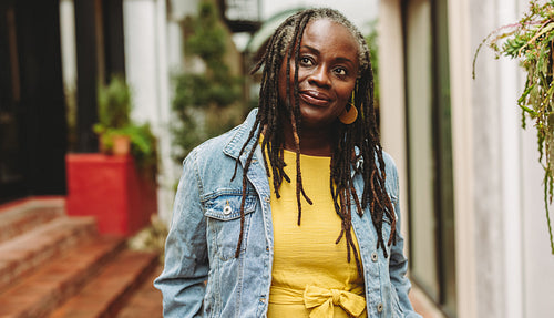 Mature woman with dreadlocks standing outdoors