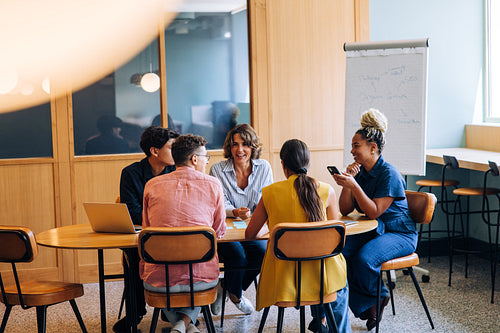 Group discussing ideas in a bright office setting around a table