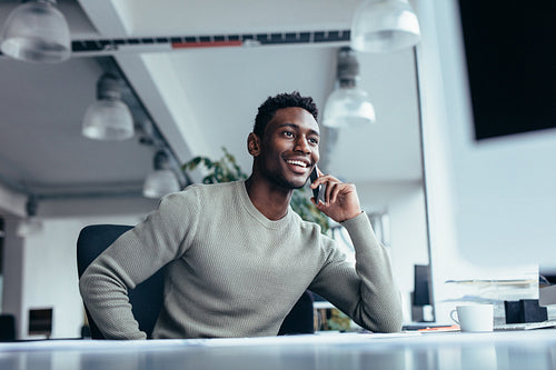 Male executive making phone call in office