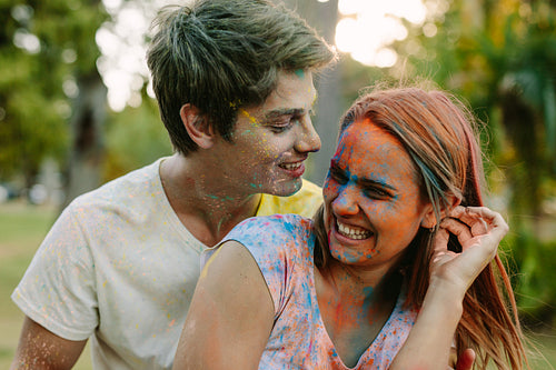 Couple playing holi outdoors
