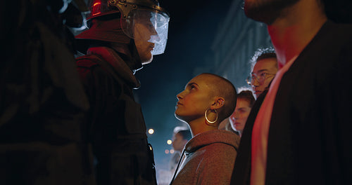 Woman activists staring at a policeman