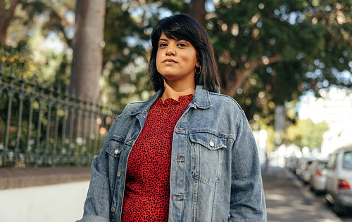 Self-confident woman looking at the camera outdoors