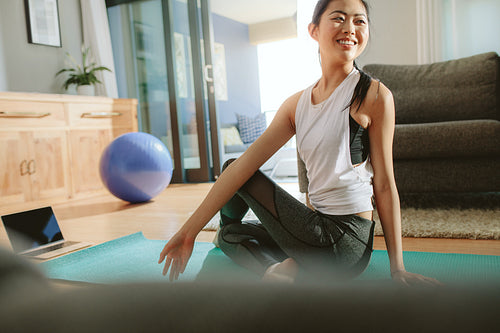 Beautiful woman practicing yoga at home
