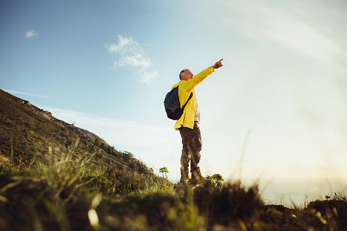 Hiker enjoying the view standing on a hill