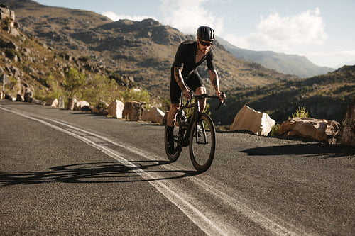 Cyclist riding uphill on a mountain road 