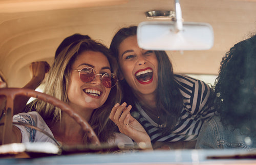 Friends going on vacation in a car and having fun