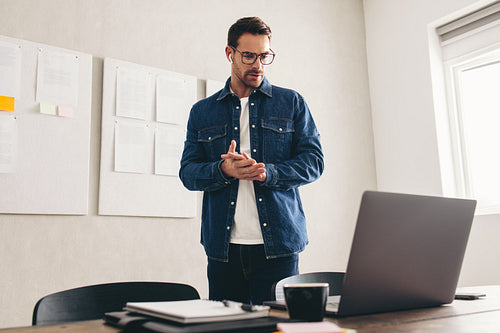 Young businessman having an online meeting with his team