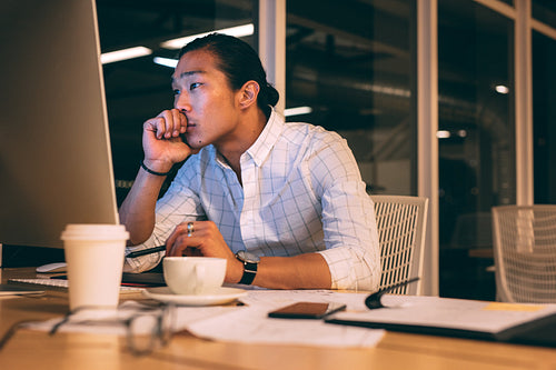 Businessman working in office looking tensed