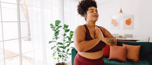 Fitness woman practicing yoga at home