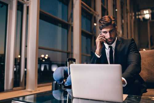 Businessman waiting for his flight at airport lounge