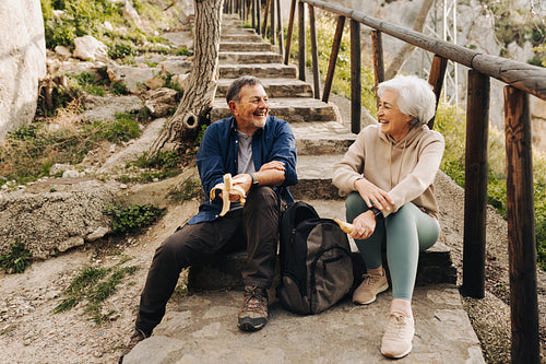 Elderly couple having some bananas outdoors