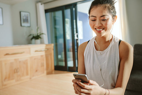 Woman taking break after exercising at home
