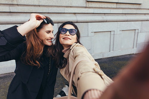 Best friends taking a selfie outdoors on the street