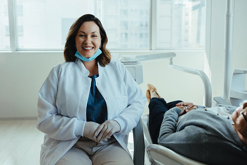 Caring dentist reassures patient in clinic consultation room