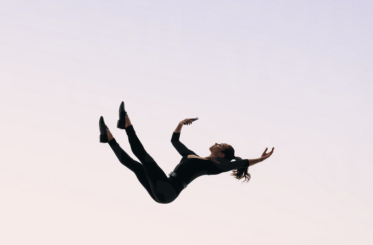 Falling into the digital depth: Woman holding cellphone, endlessly scr ...