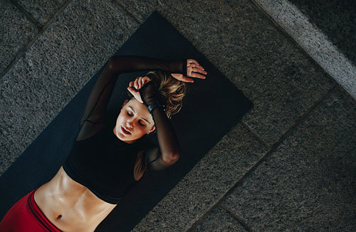 Fitness woman doing workout lying on floor